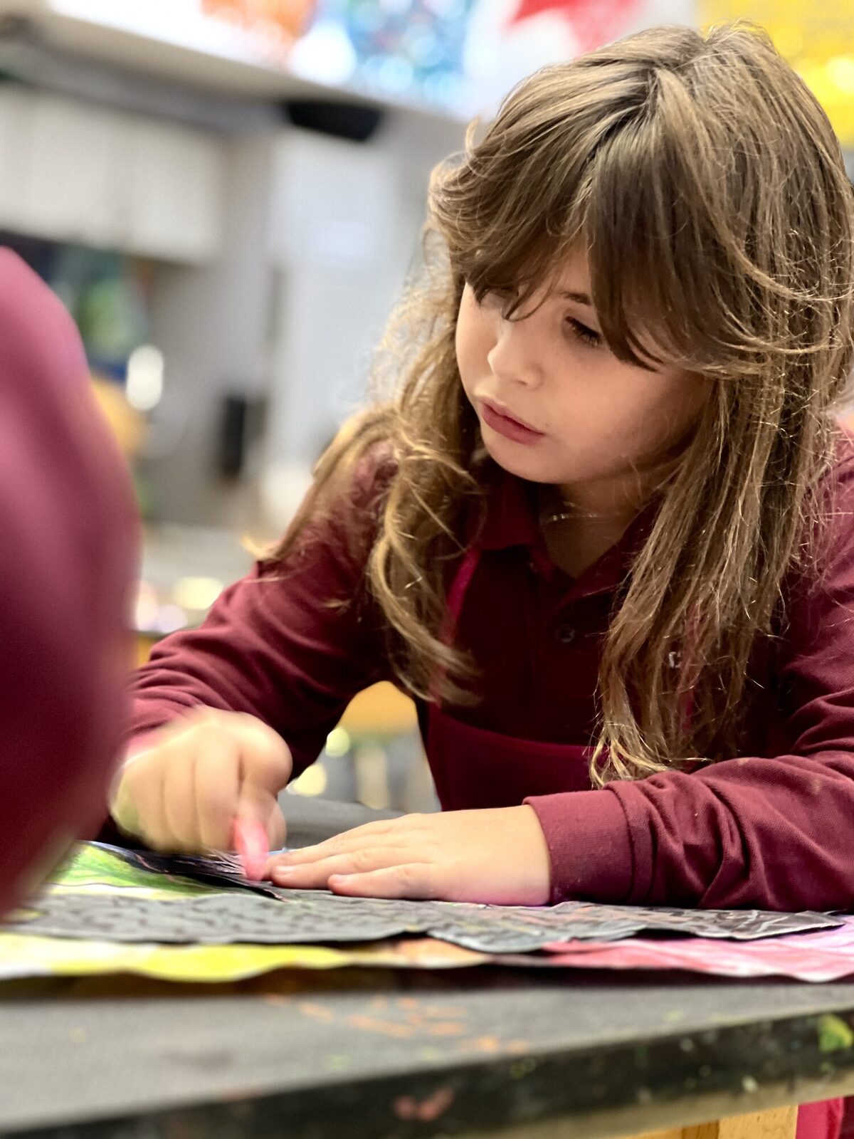 Young student focused on an art project