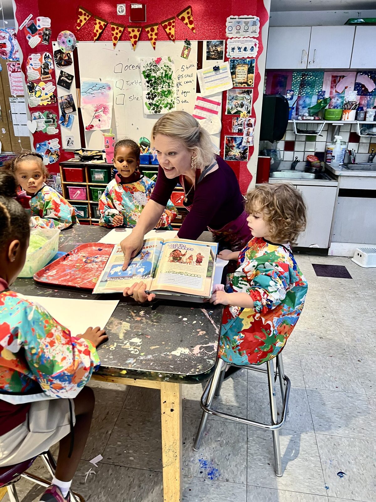 Teacher reading a picture book to preschoolers